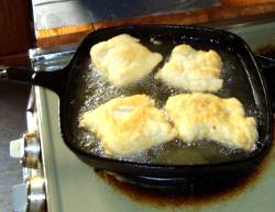 frying bannocks in frypan on top of stove